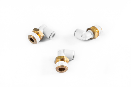 Close up and top view. Brass pneumatic parts for connecting to air ducts. Placed on white floor.の写真素材