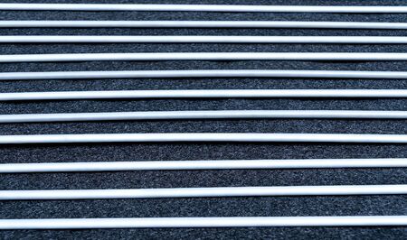 Close up view and low light. Black and white fabric sheet stacked in horizontal straight line.