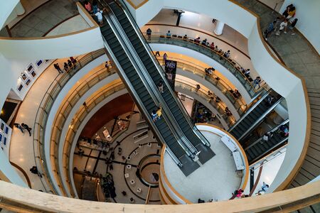 Bangkok Art and Culture Centre, Bangkok, Thailand-August 11.2019. Low light and top view of interior design the building spiral of class. There is gap and escalators in middle from below to top end.のeditorial素材
