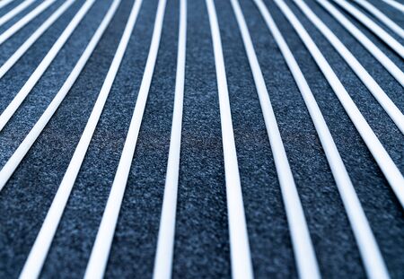 Close up view and low light. Black and white fabric sheet stacked in straight line.