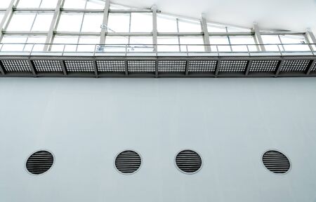 Overexposed view. Ceiling there are vents and receiving light inside the building.