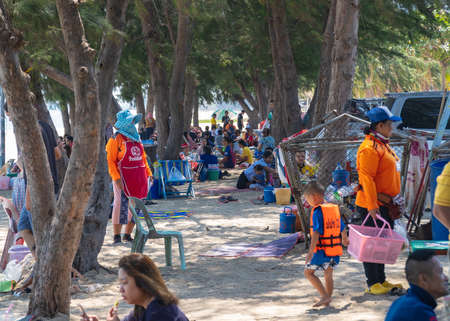 Chaosamran Beach, Phetchaburi, Thailand-March 08.2020. Trader and people take family come to tourism and leisure on coast of the beach under shade of the pine tree. During the daytime that is hot.のeditorial素材