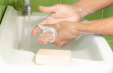 People washing hands with soap in sinks. Apply all over the arms and the nook of fingers. To get rid...