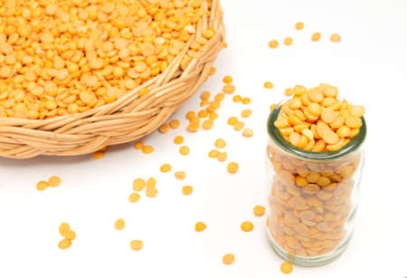 Close up view on white studio. Soybean seed in clear glass bottle and spread on white floor with...
