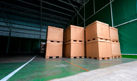 Low light view and copy space of Warehouse with lots of old cardboard boxes. Overlapping in the...