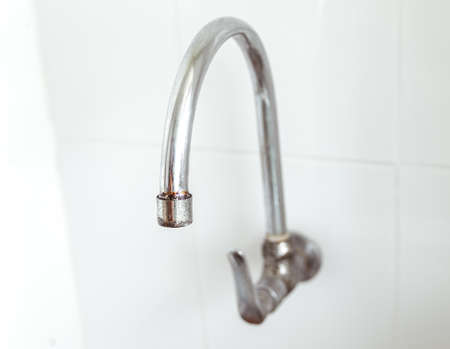 Close up view. Curved shape of old faucet and has rust at the tip.の写真素材