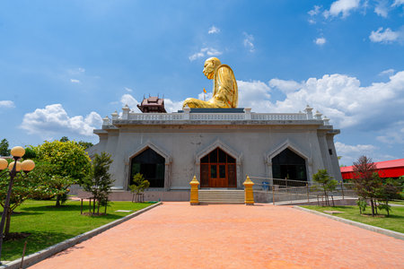 Wat Lahan Rai, Rayong, Thailand-February 24.2024. The large golden statue of a monk is popular with people and tourists. Who come to worship and pray for blessing.のeditorial素材