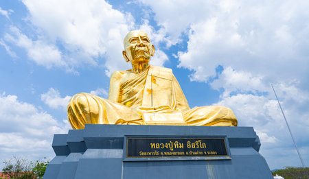 Wat Lahan Rai, Rayong, Thailand-February 24.2024. The large golden statue of a monk (Luang Pu Tim) is popular with people and tourists. Who come to worship and pray for blessing.のeditorial素材