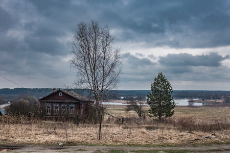 Spring landscape in the village of Russia, with wooden houses and trees.の写真素材