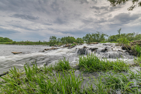 Summer landscape. River, riverside and sky. Rolls on a mountain river under the blue skyの写真素材