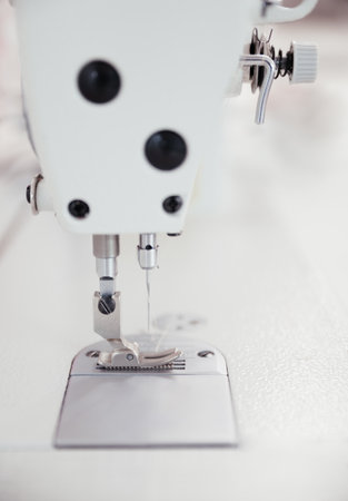 Close-up shot of needle and thread of sewing machine. Presser foot in sewing machine threading the...