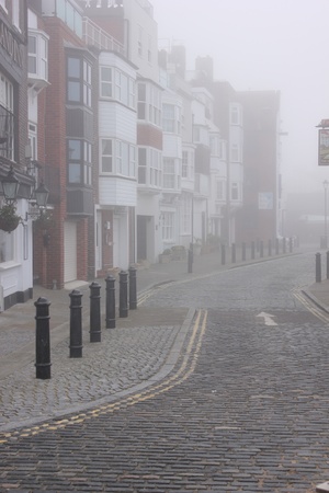 an old cobblestreet in sallyport portsmouth during a foggy day