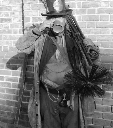 Victorian chimney sweep wearing his old clothes & carrying his brushのeditorial素材
