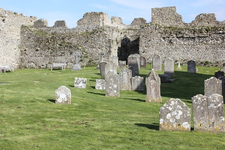 A church and graveyard within the walls of a medieval castle
