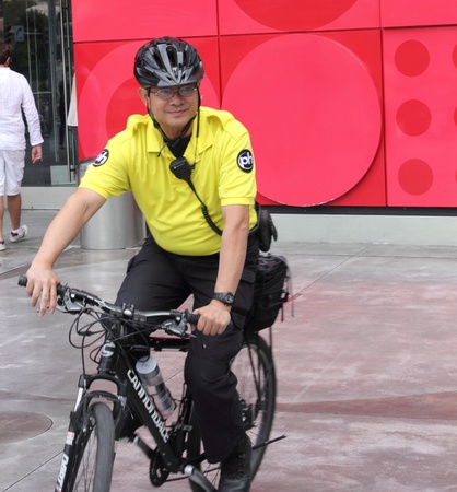 Security person riding his bicycle along the Las Vegas strip wearing his uniform,april 2013