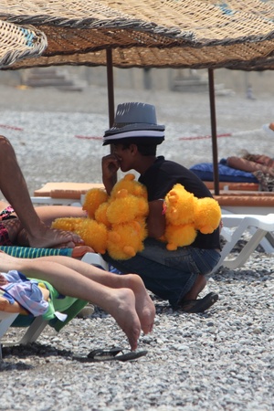 TURKEY,CALIS,JULY 2013 - A local selling his goods along the beach at Calis in Turkeyのeditorial素材