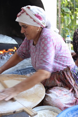 TURKEY,CALIS, 1st AUGUST 2013 - Old Turkish ladies making traditional turkish bread and pancakesのeditorial素材