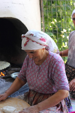 TURKEY,CALIS, 1st AUGUST 2013 - Old Turkish ladies making traditional turkish bread and pancakesのeditorial素材