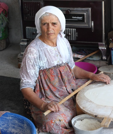 TURKEY,CALIS, 1st AUGUST 2013 - Old Turkish ladies making traditional turkish bread and pancakesのeditorial素材