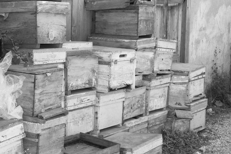 Old wooden boxes stacked against a building の写真素材