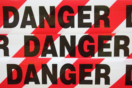 Danger tape being used as a sign to warn people not to enter area as it is dangerous 
