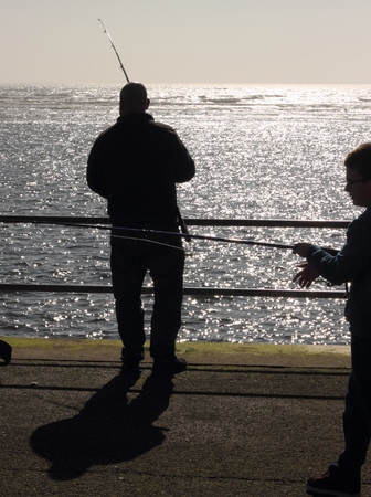 AVON, HAMPSHIRE, ENGLAND 9TH MARCH 2014  A father and son fishing at Avon in hampshire in england ,9th march 2014のeditorial素材