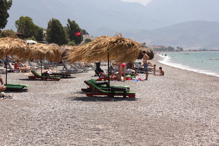 Sunbeds and umbrellas at Calis beach in Turkey,2014のeditorial素材
