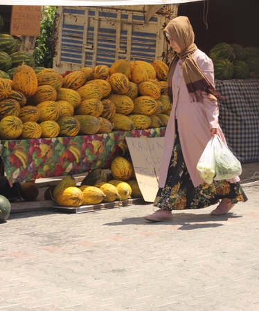 A turkish lady with her purchases from a local market in calis, turkey 2014のeditorial素材
