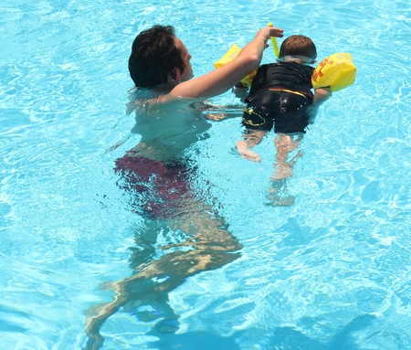 A young boy learning to snorkel in a clear water swimming pool during the summer of 2014のeditorial素材