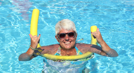Lady relaxing in the swimming pool while on holiday
