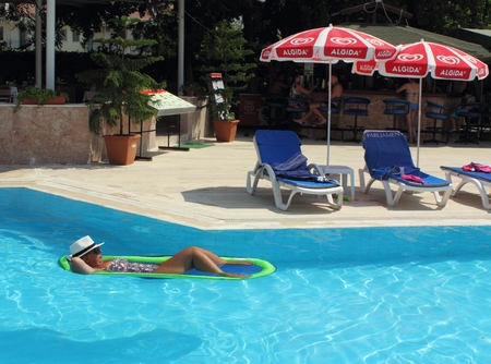 CALIS, TURKEY, 2ND AUGUST 2015:An english Lady relaxing  in a swimming pool while on holiday in calis, turkey ,2nd august 2015のeditorial素材