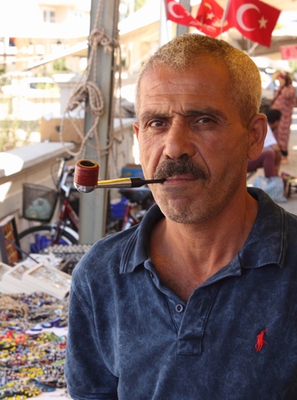 A turkish male smoking a pipe while at a local market in calis in turkey,19th july 2015のeditorial素材
