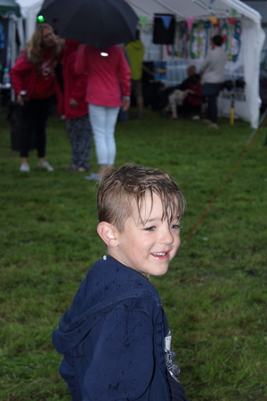 A young boy getting wet while playing in the rain ,august 2015のeditorial素材