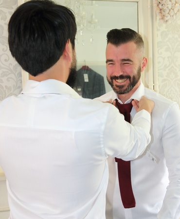2ND JULY 2016, PORTSMOUTH,ENGLAND: A bestman helping the groom get dressed for his wedding in portsmouth, england, 2nd july 2016のeditorial素材