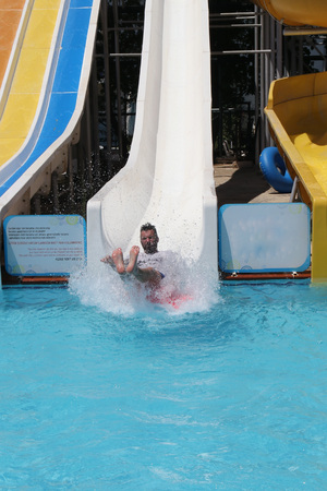 An englishman having fun on a water slide in a waterpark while on vacation in turkey