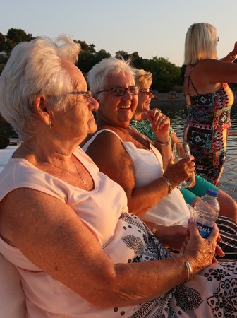 14TH JULY 2017, FETHIYE, TURKEY: A group english ladies on a sunset boat trip during the evening while on vacation in fethiye, turkey, 14th july 2017のeditorial素材