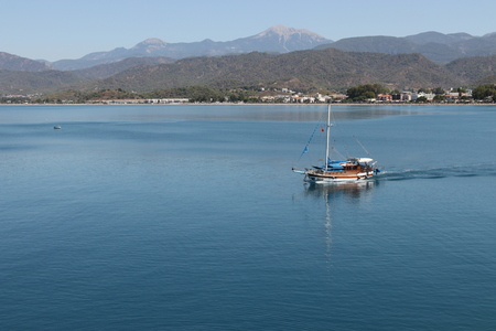 28TH JULY 2017,FETHIYE,TURKEY: A motor boat in the calm waters at calis,fethiye in turkey, 28th july 2017のeditorial素材