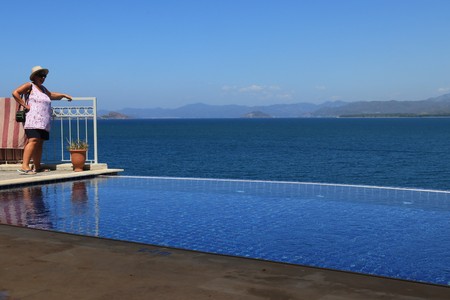 28TH JULY 2017: An English lady looking out on the bays of Fethiye from an infinity pool at, Fethiye in Turkey,28th July 2017のeditorial素材