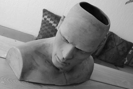 A clay model of a males head and shoulders in black and whiteの写真素材