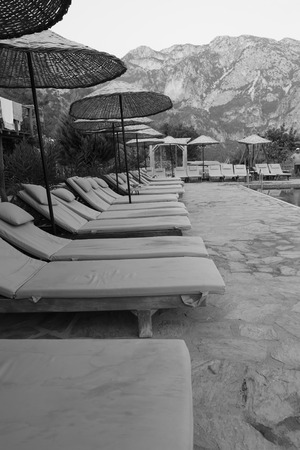 30TH JULY 2017, KABAK, TURKEY:A relaxing poolside area with sunbeds in black and white at Kabak in Turkey, 30th july 2017のeditorial素材