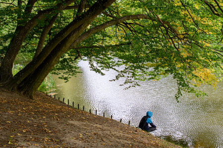 A man fishing in a city park