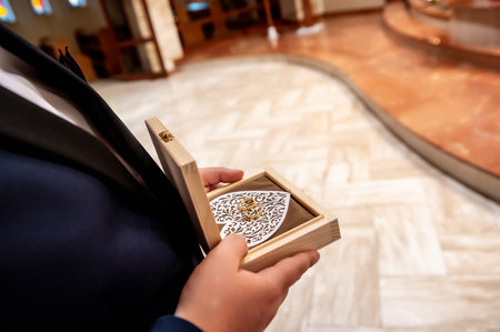 wedding rings and details the groom's witness holds a box with wedding rings in his hands