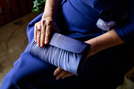 hands, wedding rings and marriage vows mother's hands in a purple dressの写真素材