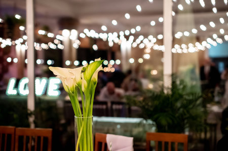 wedding hall interiors and decorations a bouquet of lilies in the wedding hall with a picturesque blurred backgroundの写真素材