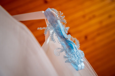 bride and groom's wardrobe and items of clothing blue bridal garter on clothes hangerの写真素材