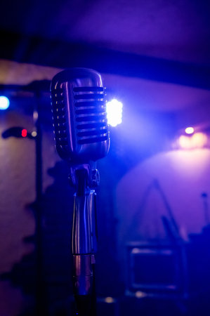 retro style microphone on stage lights backgroundの写真素材