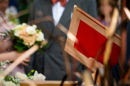 mayor holding red official decorative folder for documents on weddingの写真素材