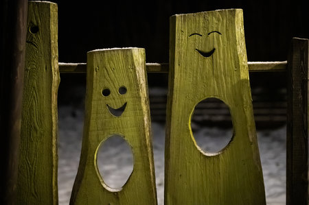 funny faces cut in wooden boardsの写真素材