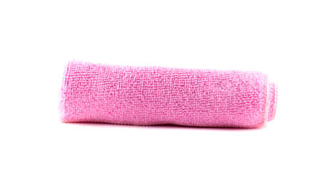 Pink towel rolled up on a white backgroundの写真素材