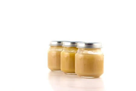 Three jars with fruit puree each other in an oblique rowの写真素材